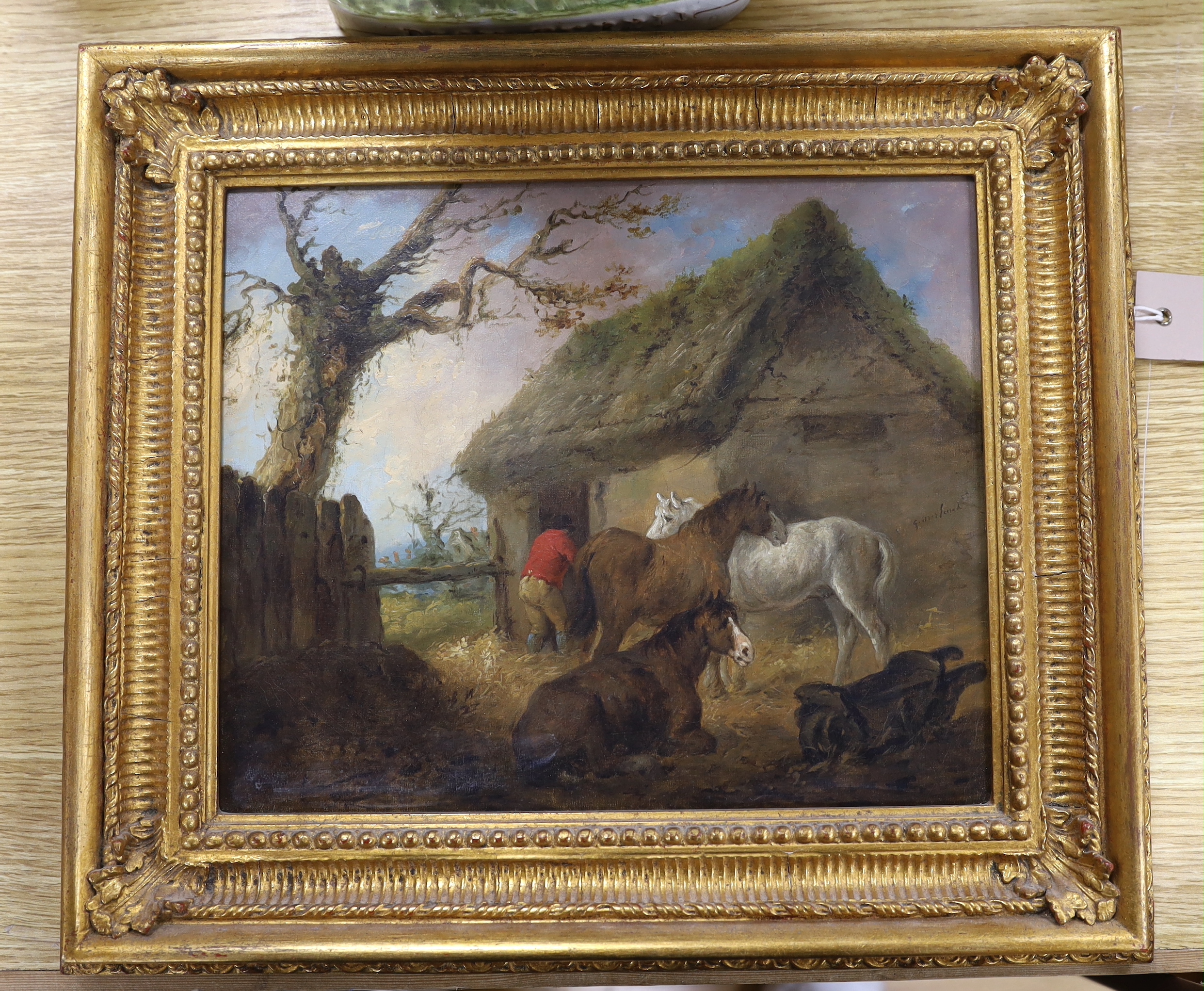 Follower of George Morland (1762/63-1804), oil on canvas, Horses before a thatched stable, bears signature, 24 x 29cm